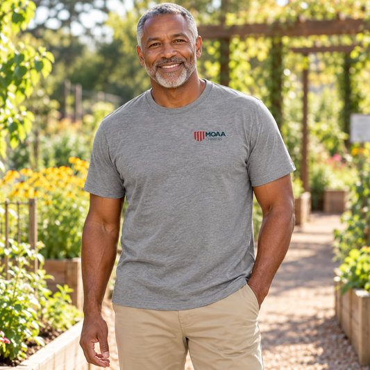 Older adult man wearing the MOAA Charities Tee in a lifestyle setting.