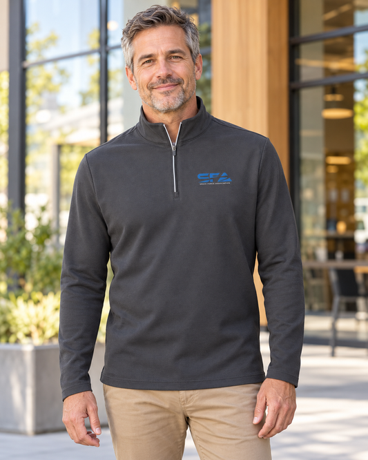 Man wearing the charcoal Men's SFA Quarter Zip outside a modern building, showing the royal blue SFA logo.