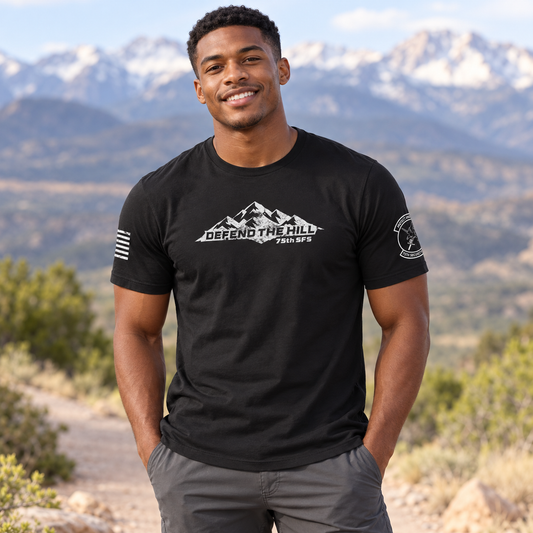 Lifestyle view of 75 SFS Black Tee outdoors.