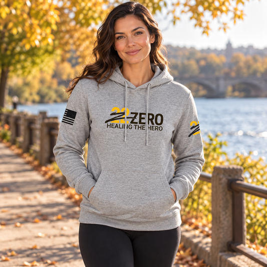 Healing the Hero Heather Gray Hoodie worn by an adult woman outdoors; front view.