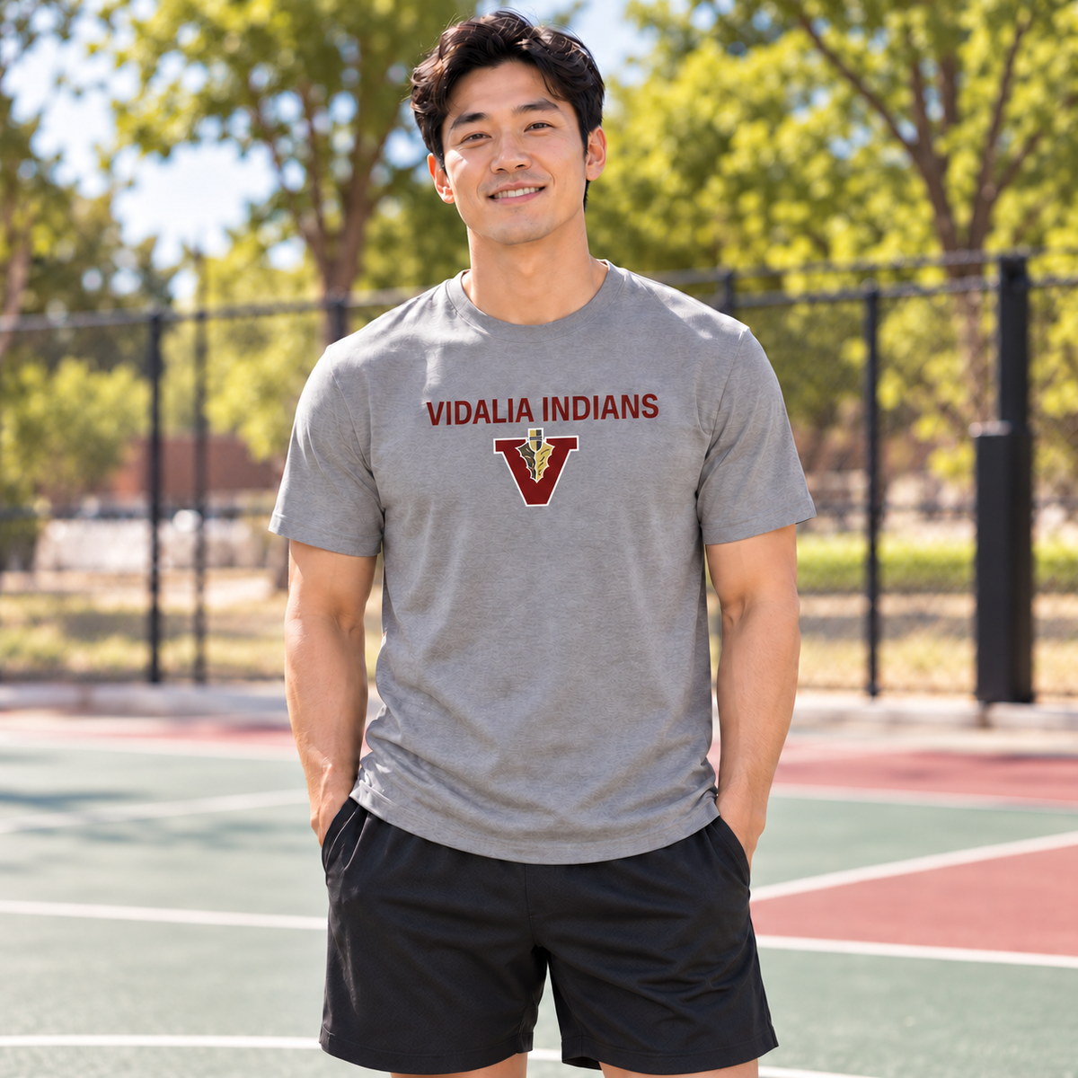 Man wearing the unisex Vidalia Indians Tee in heather gray with Vidalia Indians lettering and V-and-spear graphics