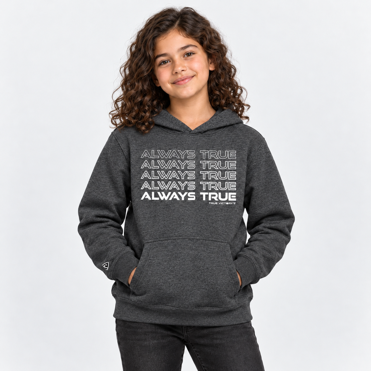 Child model wearing the Youth Always True Stacked Hoodie in heather charcoal with white print